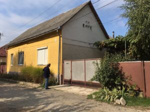 A man by his house