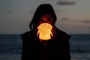 A woman holding the moon