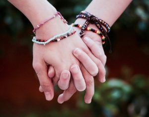 Friends holding hands