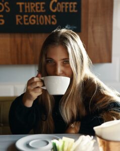 A woman sipping from her mug